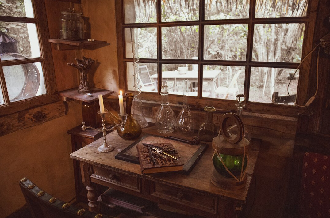 Desk with an open book, notes and a cup of coffee