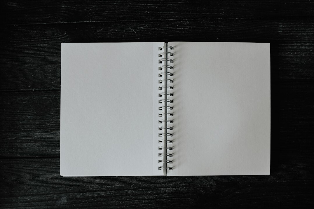 Open notebook with pen on a wooden desk